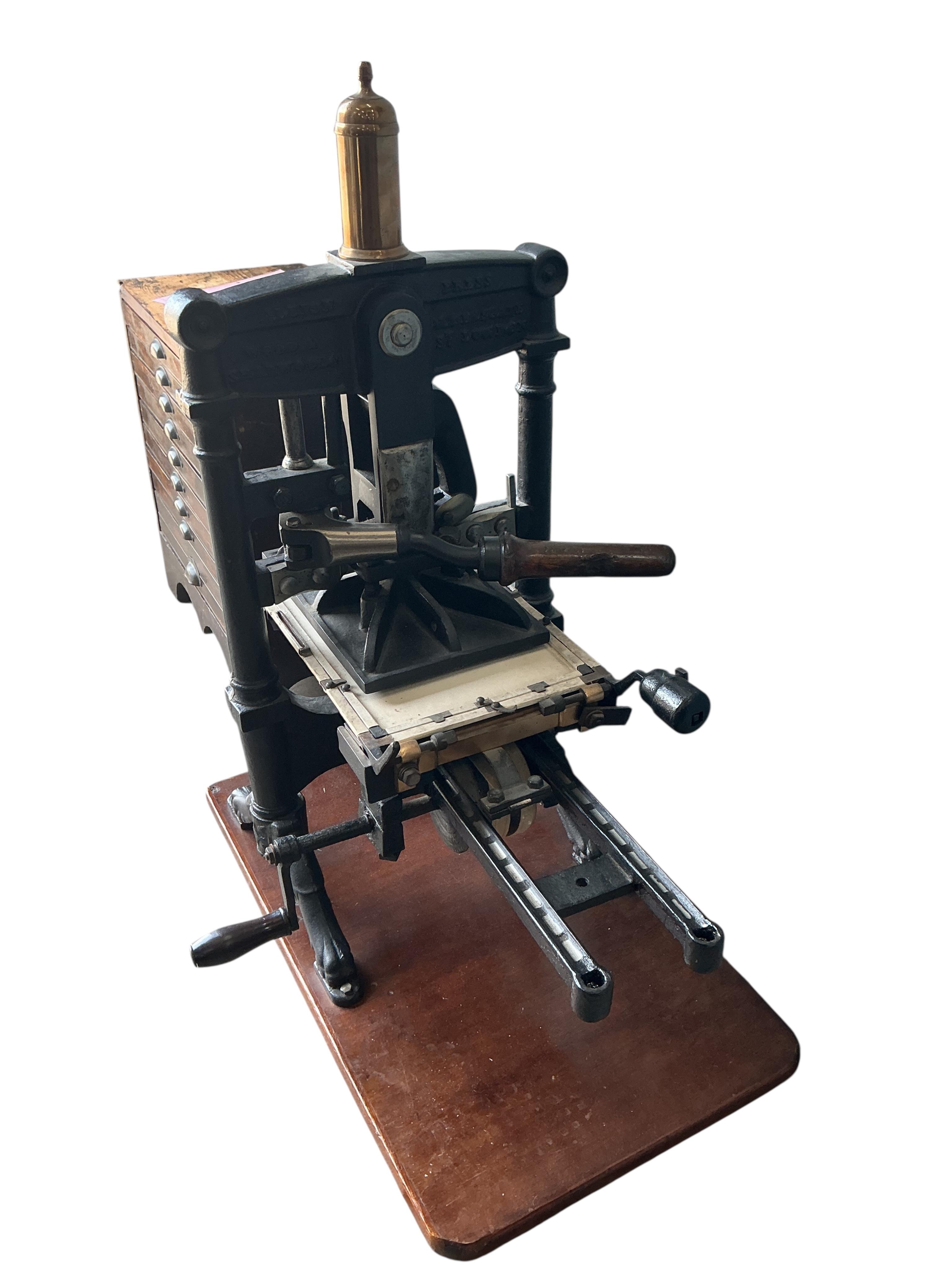 A Victorian cast iron Albion printing press by Wood and Sherwood, Aldersgate Street, London, width 87cm, height 105cm, together with a stained pine chest of print making accessories. Provenance: This was the property of
